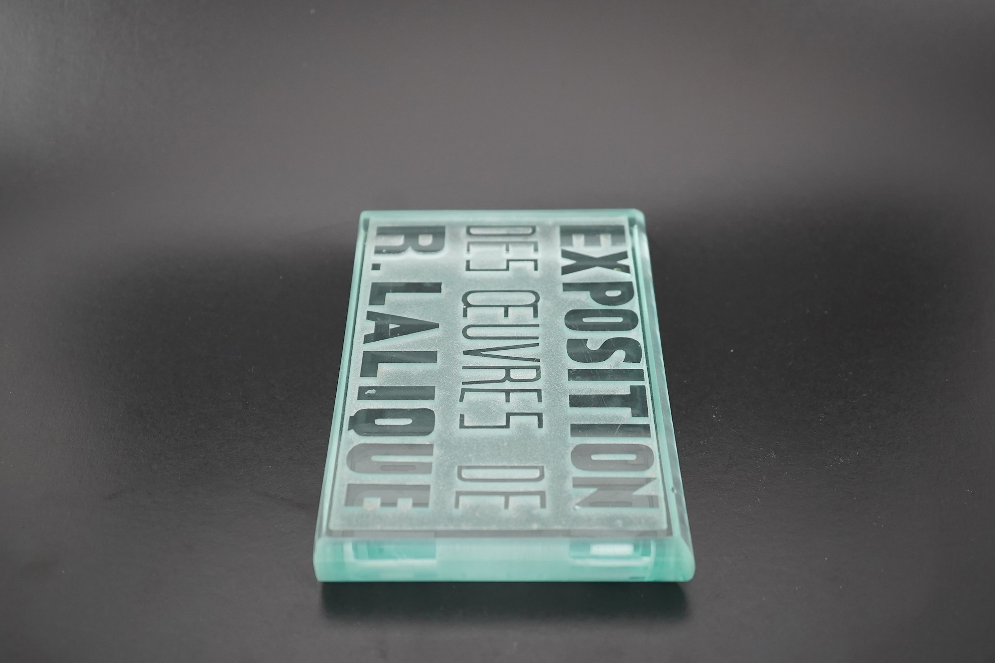 Lalique: A glass advertising plaque 'EXPOSITION DES ŒUVRES DE R.LALIQUE'